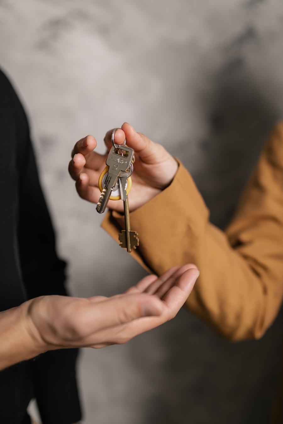 Two people exchanging house keys