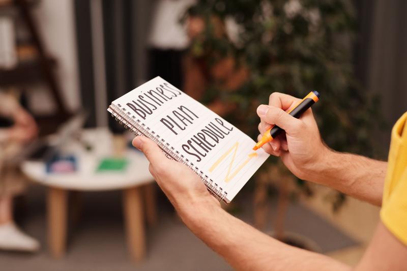 Hand writing in a business plan notebook
